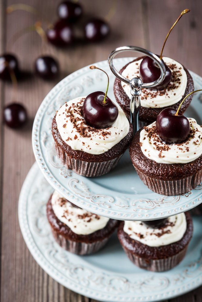 Chocolate,Cupcakes,With,Cherries,On,A,Plate,On,Wooden,Background